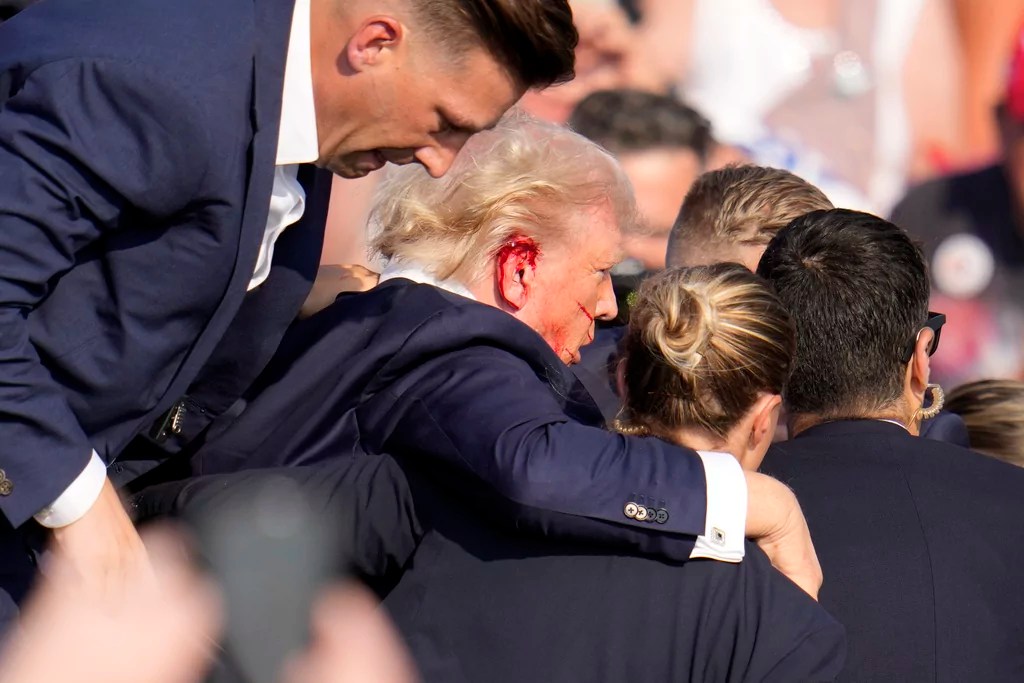 Trump evacuated from rally after shots fired in apparent assassination attempt